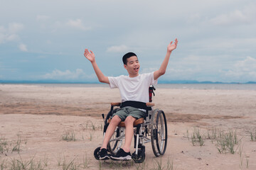Happy handicapped teen smiling face, Sea beach background, Lifestyle happy disabled child travel , Good mental health concept