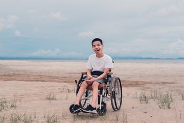 Fototapeta premium Happy handicapped teen smiling face, Sea beach background, Lifestyle happy disabled child travel , Good mental health concept