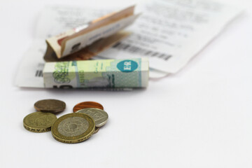 British pound notes and coins on receipts
