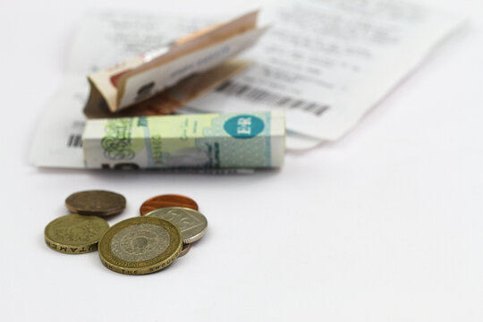 British pound notes and coins on receipts