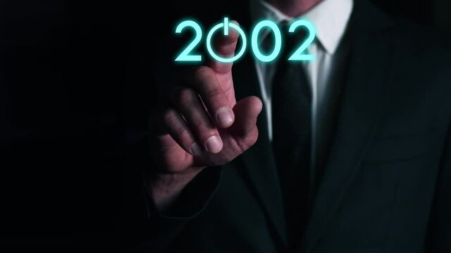 businessman presses on the virtual start button to load the date of the new year. The concept of future technologies in business development