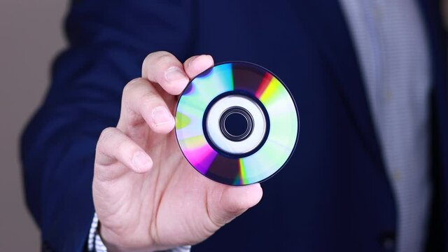 Man showing mini compact disc