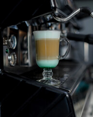three-layer coffee standing on the coffee machine - 457905759
