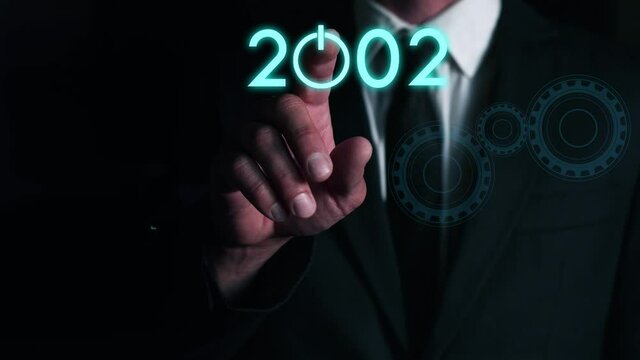 businessman presses on the virtual start button to load the date of the new year. The concept of future technologies in business development