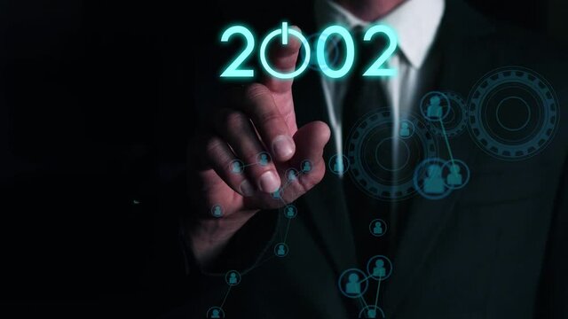 businessman presses on the virtual start button to load the date of the new year. The concept of future technologies in business development