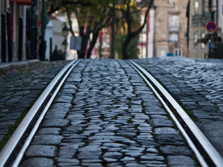 Tram tracks in stone paved street, Lisbon