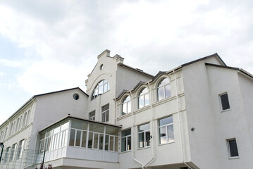 building against the backdrop of a dramatic sky with clouds