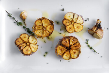 Roasted garlic with thyme and oil, top view