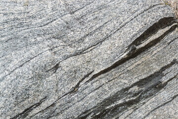 Untreated natural texture of gray granite close-up. Abstract background, texture, pattern, wallpaper.
