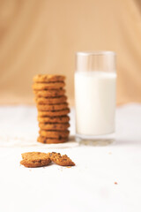 A tower of biscuits with a glass of milk