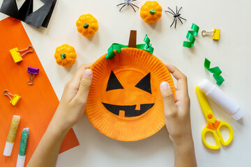 Cuts of paper for Halloween. Hand cut paper. Pumpkins. Scissors and glue. On a light background....