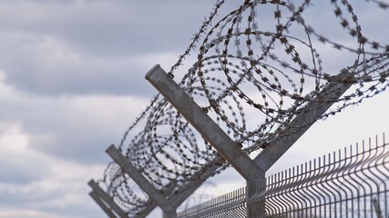 Metal Fence with Barbed Wire Securing Restricted Area Military Zone Border during Refugee...