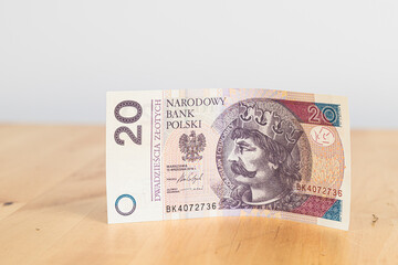 20 PLN (twenty Polish zlotys on a wooden table