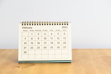 February 2022 calendar on wooden table