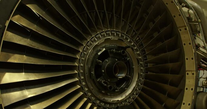 Concept of aircraft maintenance.  Close-up footage of a jet turbine engine.