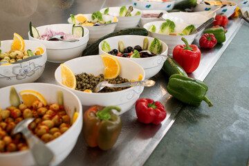 photo of a bowl with olives and capers on the buffet