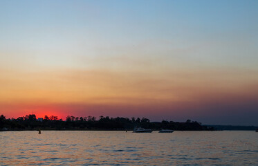 Pôr do sol avermelhado visto do Lago Paranoá em Brasília.