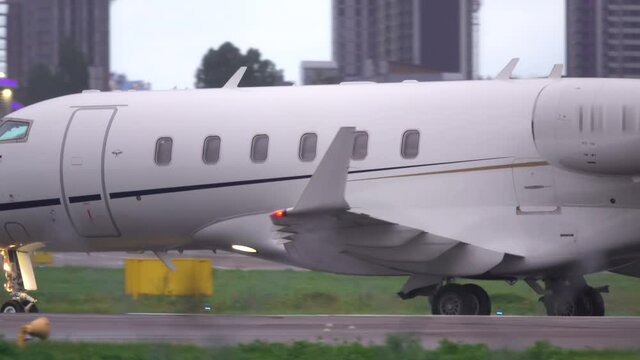 Business jet is taxiing on the runway after landing. Side view