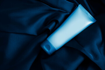 cosmetic cream on silk background