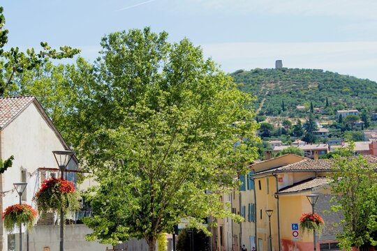 Beautiful view on an old historic medieval town of Manosque in Provence, France, in Europe, not far from French Riviera. Green summer landscape and cityscape on a hill, dream European vacation.