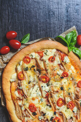 pizza on a table with pear and blue cheese