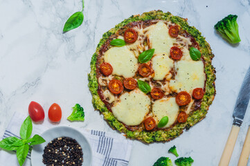 broccoli pizza crust with cherry tomatoes and mozzarella cheese