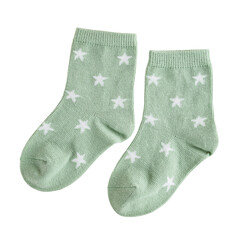 children's textile cotton soft socks green with a star pattern, warm woolen for kids, isolated on a white background, close-up