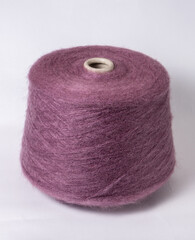 bobbin of yarn on a white background. Side view.Textile reel on