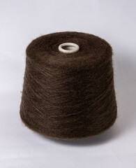 bobbin of yarn on a white background. Side view.Textile reel on