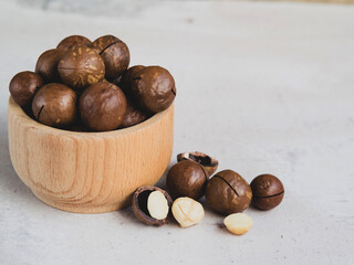 natural organic macadamia nuts in a wooden bowl