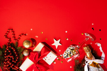 New Year celebration. Xmas background. Christmas eve 2021. Gift box champagne golden confetti bauble fir tree festive collection bottom border isolated on red copy space.