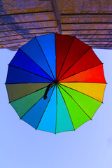 Selective focus, eye-catching colorful street parasol of vibrant rainbow-like colors