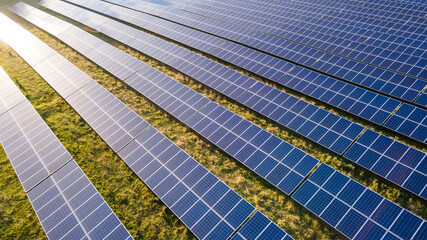Aerial view of the solar panel in solar farm in evening sun light.