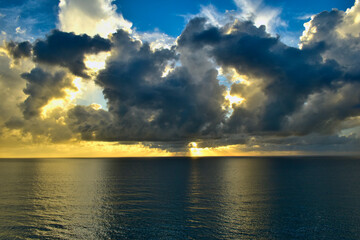 Dramatic sun rising behind storm clouds off the coast of Florida