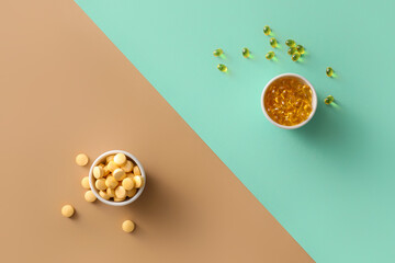 Bowls with pills on color background