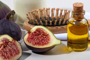Fresh fig fruits and essential oil close up. Recipe for hair care.