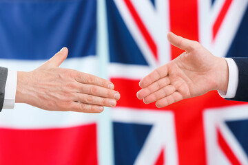 Business people handshaking against the flags of Great Britain and France