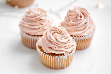 Tasty wedding cupcakes on table