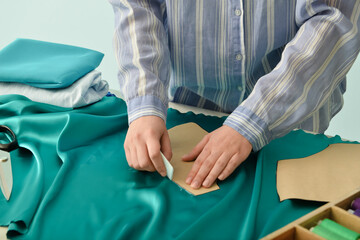 Young woman working with cloth at table