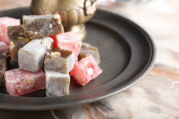 Tray with Turkish delight on grunge background, closeup