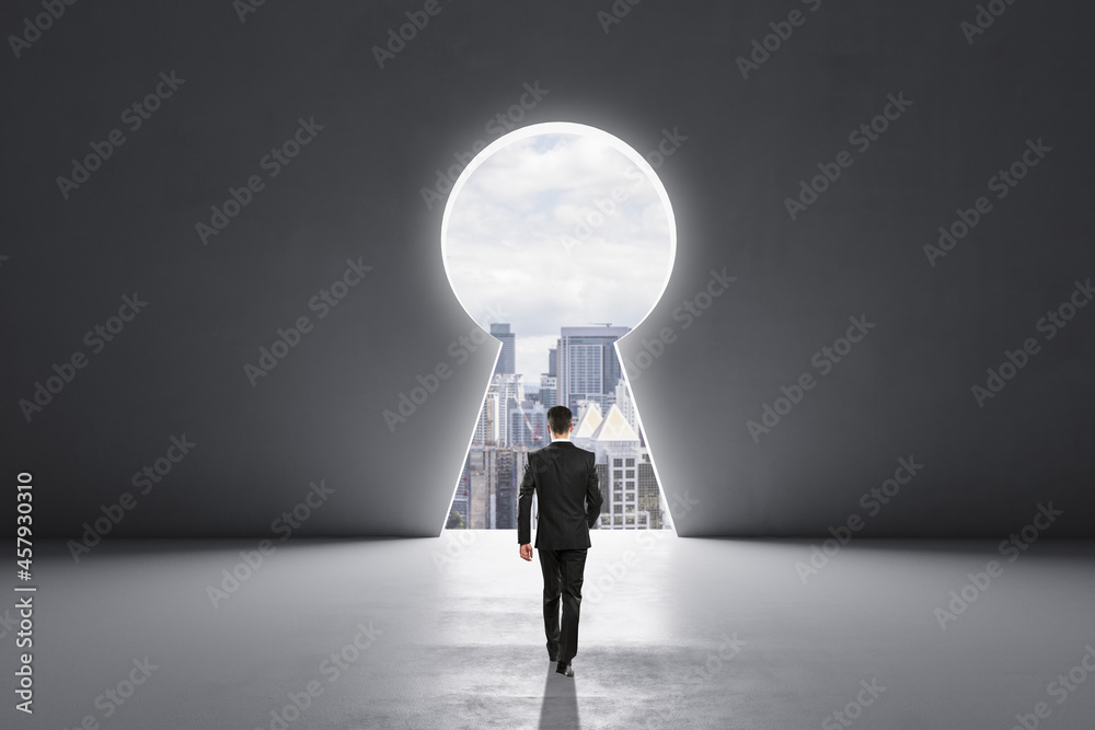 Poster back view of businessman walking in concrete interior with abstract keyhole window with city view. k