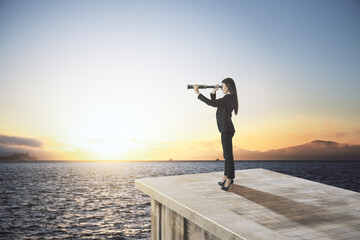 Businesswoman with binoculars standing on abstract concrete roof looking at water and sunset sky...