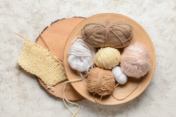 Fototapeta na wymiar Wooden board with knitting yarn and needles on light table