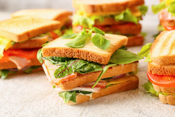 Tasty sandwiches on light background, closeup