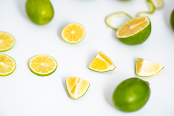 Flat lay view green lime lemons over isolated white backdrop.Includes copy space.