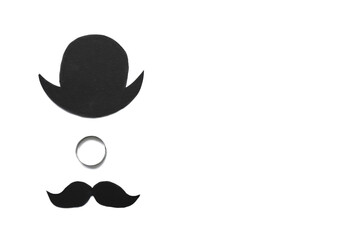 Fototapeta premium Wedding ring, paper hat and mustache on white background