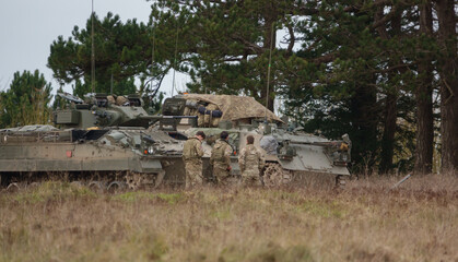 British army Warrior FV510 light infantry fighting vehicle and FV432 Bulldog on a military exercise...
