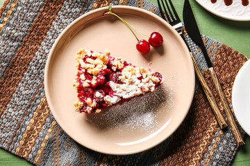 Plate with piece of tasty cherry pie on color wooden background, closeup