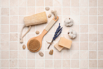Fototapeta na wymiar Composition with body brush and bath supplies on light tile background