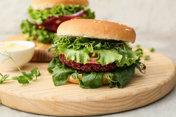 Wooden boards with tasty vegetarian burgers on table